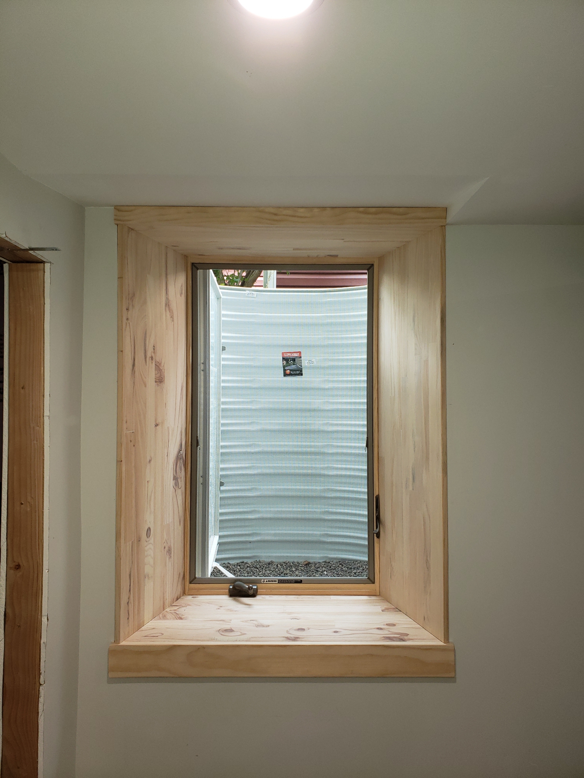 Oak interior egress window trim installed in basement Twin Cities Metro MN