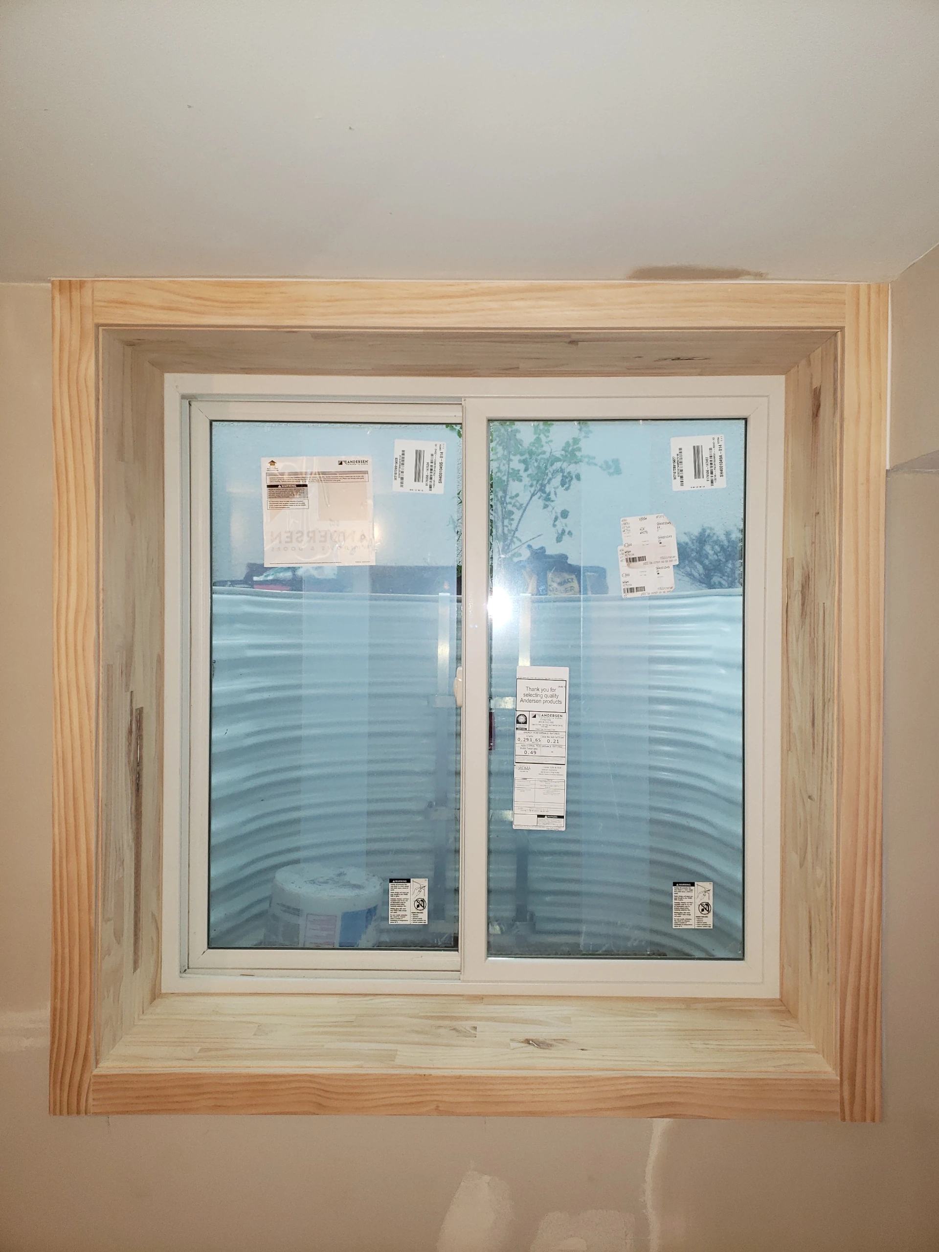Pine interior egress window trim installed in basement
