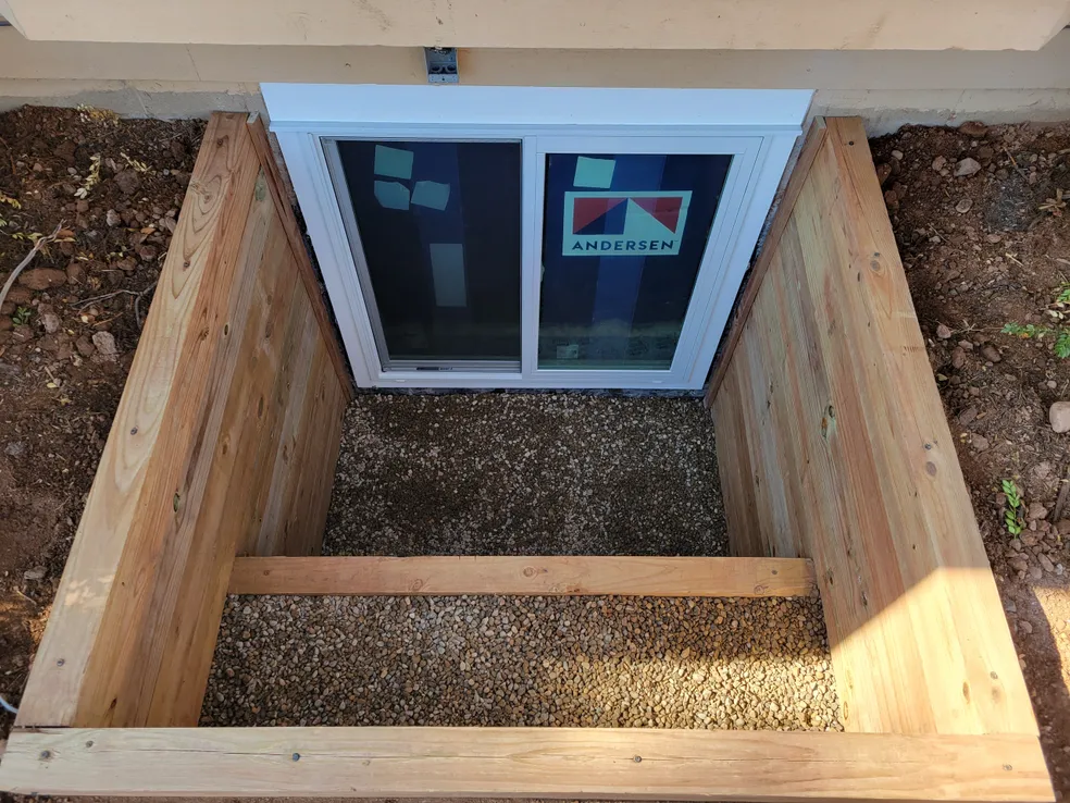Aerial view double timber egress well with gravel