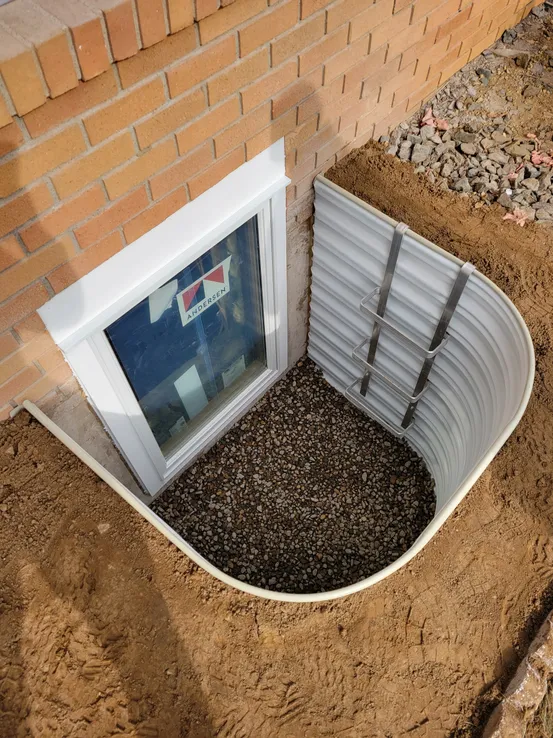 Metal well egress installation on brick home